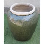 A LARGE GREEN GLAZED CERAMIC POT, modern, of ovoid form with moulded rim, 17" x 26" (Est. plus 21%