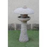 A SCOTTISH GRANITE BIRD BATH, the circular bowl surmounted by a domed lid with ball finial, on