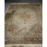 A PERSIAN STYLE CARPET, modern, the ivory field with repeating Herati flower pattern centred by a