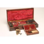AN EDWARDIAN SURGEON'S PART AMPUTATION KIT, the mahogany carrying case with red chenille lined
