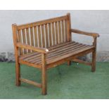 A JOINED HARDWOOD BENCH, modern, with straight top rail, open arms on square supports, slatted