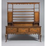 A GEORGIAN OAK AND MAHOGANY BANDED DRESSER, late 18th century, the open back delft rack with moulded