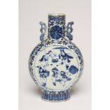 A CHINESE PORCELAIN MOONFLASK painted in underglaze blue with two roundels enclosing travelling