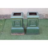 A PAIR OF CAST IRON URN PEDESTALS of stepped square form with floral panels to each side, on