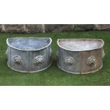 A PAIR OF LEAD PLANTERS, modern, of bevelled D form moulded with Tudor roses in high relief, 22" x