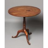 A GEORGIAN MAHOGANY TRIPOD TABLE, late 18th century, the circular tip up top on baluster and ring