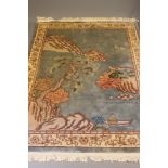 A CHINESE PICTORIAL WASHED AND FRINGED SILK RUG, modern, the pale blue field depicting a coastal