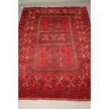 AN AFGHAN RUG in yellow, navy, black and red, the quartered field with traverse spine each with