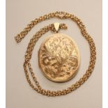 A 9CT GOLD OVAL LOCKET PENDANT, the hinged fascia with bright cut foliate engraving and fixed