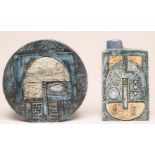 A TROIKA WHEEL VASE, with stylised Aztec faces painted in shades of blue and buff, 8" high, together