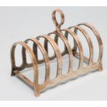 A SILVER SEVEN BAR TOASTRACK, maker Frank Cobb, Sheffield 1926, of plain arched form with central