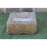 A SANDSTONE TROUGH of rough hewn square form, 25" x 11 1/2" (Est. plus 21% premium inc. VAT)