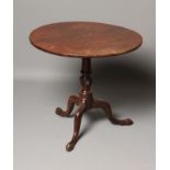 A GEORGIAN MAHOGANY TRIPOD TABLE, late 18th century, the circular tip up top on a ring and wrythen