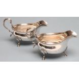 A PAIR OF SILVER SAUCE BOATS, maker Adie Bros. Ltd., Chester 1923, the oval bowls with cast and