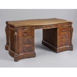 A GEORGIAN DESIGN MAHOGANY PEDESTAL LIBRARY DESK, 20th century, of oblong serpentine form, the