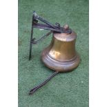 A BRONZE BELL, 20th century, on a cast iron wall bracket, the iron clanger with leather strap,