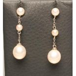 A PAIR OF CULTURED PEARL DROP EAR STUDS, the two graduated pearls drilled and pendant from fine