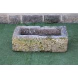 A SANDSTONE TROUGH of rough hewn oblong form, 34" x 17 1/2" x 11 1/2" (Est. plus 21% premium inc.