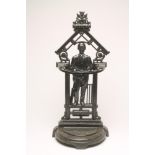 A VICTORIAN CAST IRON "CRICKETER" STICK STAND of semi circular outline with drip tray to base, the