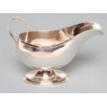 A SILVER SAUCEBOAT, maker Deakin & Francis, Birmingham 1929, the plain oval bowl with acanthus