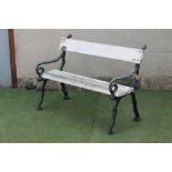 A VICTORIAN CAST IRON PARK BENCH, the truncated branch ends supporting a two plank seat and single