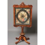 A VICTORIAN ROSEWOOD FIRE SCREEN, the oblong petit point floral screen within a banded surround edge