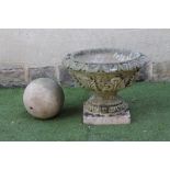 A COMPOSITION STONE URN, the stiff leaf moulded bowl on turned socle with ovolu banding and square