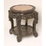 A CHINESE CARVED PADOUK WOOD JARDINIERE STAND, c.1900, of shaped circular form, the beaded edged top