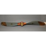 A LARGE WW1 PROPELLOR of wood construction, painted in naval grey, bearing transfer and stamps for