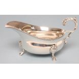 A SILVER SAUCEBOAT, maker Greenwood & Sons, London 1939, the oval bowl with cast and applied