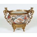 A LARGE JAPANESE IMARI PORCELAIN BOWL of oval baluster form, painted in typical palette with