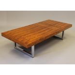 A GORDON RUSSELL ROSEWOOD VENEERED COFFEE TABLE, the plain oblong top raised on square section