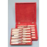 A SET OF TWELVE LATE GEORGE III SILVER DESSERT KNIVES, no maker's mark, Sheffield 1817, with angular