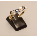 A FIVE STONE DIAMOND AND SAPPHIRE HALF HOOP RING, the three diamonds and two sapphires claw set to a
