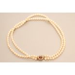 A DOUBLE STRAND CULTURED PEARL NECKLACE, the seventy two and sixty eight pearls strung to a 9ct gold