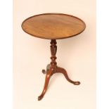 A GEORGIAN MAHOGANY TRIPOD TABLE, c.1800, the dished circular hinged top on a ring and part