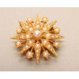 A 9CT GOLD AND SEED PEARL TARGET BROOCH/PENDANT, indistinct hallmark, possibly London 1984,