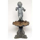 A LEAD FOUNTAIN, early 20th century, cast as a naked boy standing on an escallop shell supported