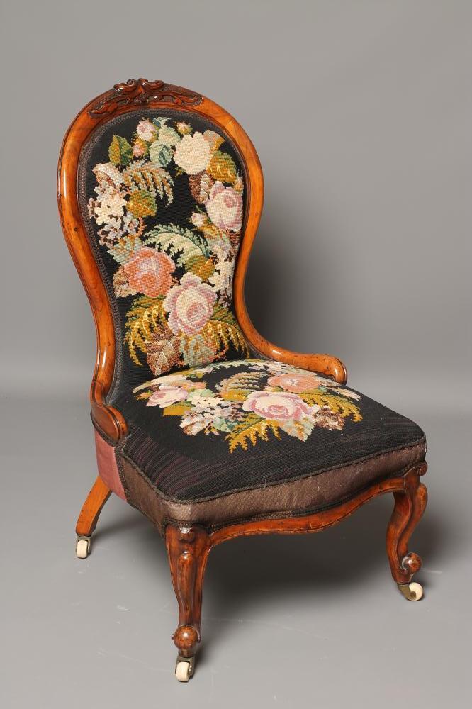 A VICTORIAN WALNUT FRAMED NURSING CHAIR of spoon back form upholstered in gros point with flowers on