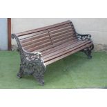 A VICTORIAN CAST IRON PARK BENCH, the ends pierced and cast with foliate scrolls centred by a