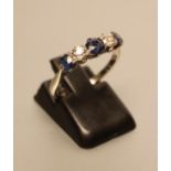 A FIVE STONE SAPPHIRE AND DIAMOND RING, the three sapphires and two diamonds claw set to a white