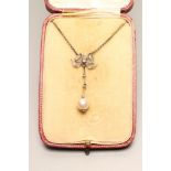 AN EDWARDIAN DIAMOND AND PEARL DROP PENDANT, the tear shaped pearl on a double knife edge bar, and