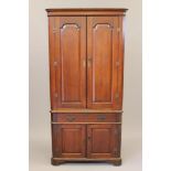 A GEORGIAN OAK STANDING CORNER CUPBOARD, mid/late 18th century, the cavetto moulded cornice over a