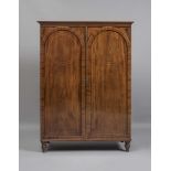 AN IRISH MAHOGANY AND STRING INLAID LINEN PRESS, early 19th century, the cavetto moulded cornice