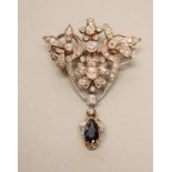 A VICTORIAN DIAMOND AND SAPPHIRE BROOCH/PENDANT, the open foliate shield set with numerous mix cut