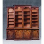 A VICTORIAN MAHOGANY BREAKFRONT LIBRARY BOOKCASE, the stepped and moulded cornice over four arched
