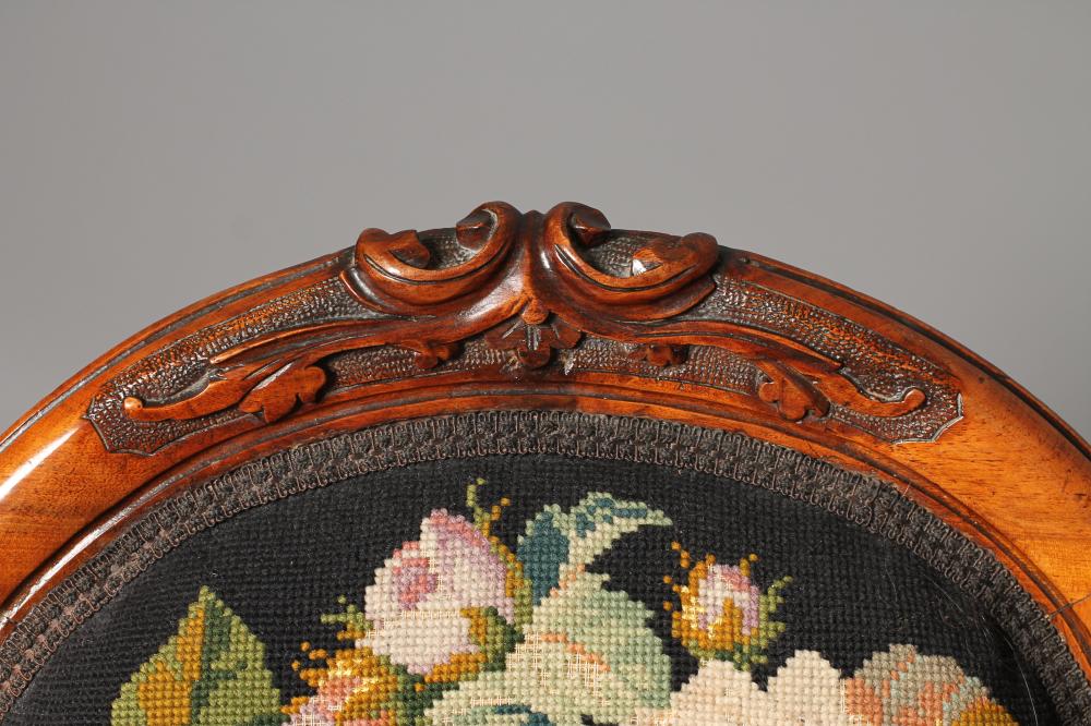 A VICTORIAN WALNUT FRAMED NURSING CHAIR of spoon back form upholstered in gros point with flowers on - Image 3 of 3