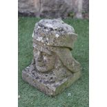 A CARVED SANDSTONE BUST of a Renaissance man wearing a hat, on square plinth, signed with initials