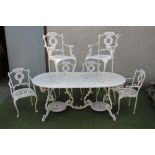 A SEVEN PIECE CAST METAL GARDEN SET, modern, the D ended wavy edged table with pierced scrolling