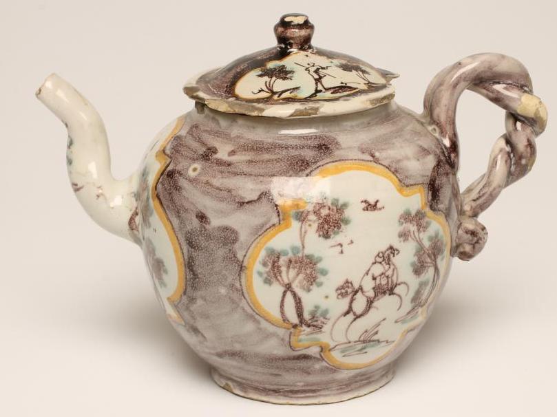 AN ITALIAN FAIENCE TEAPOT AND COVER, late 18th century, probably Savona, of globular form with